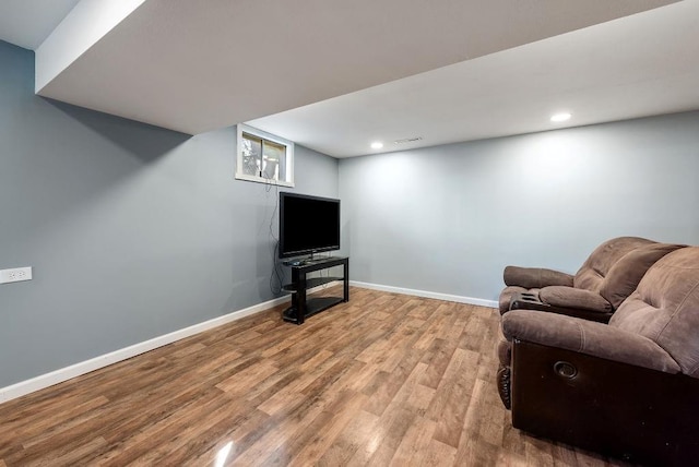 living area featuring recessed lighting, baseboards, and wood finished floors