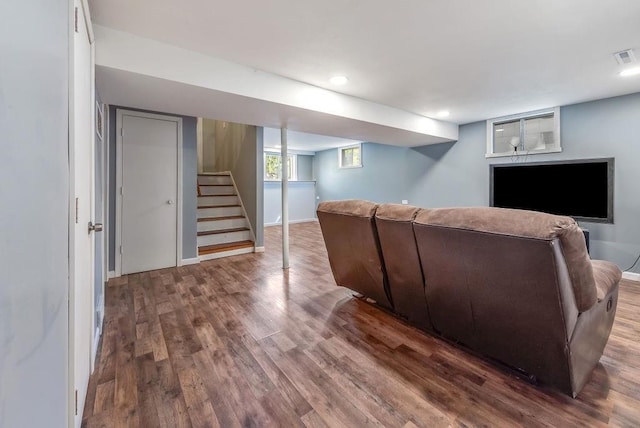 living area with stairway and wood finished floors