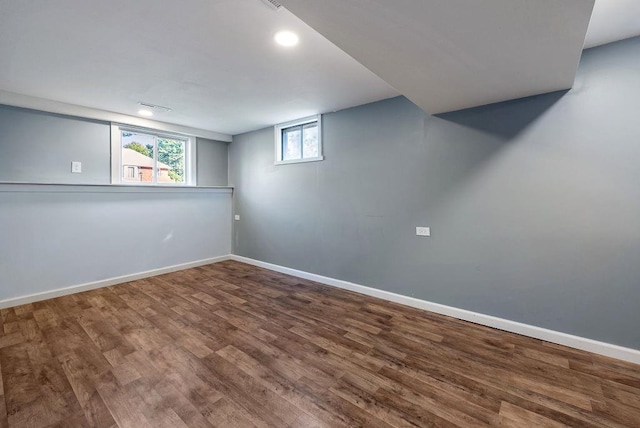 below grade area with wood finished floors and baseboards