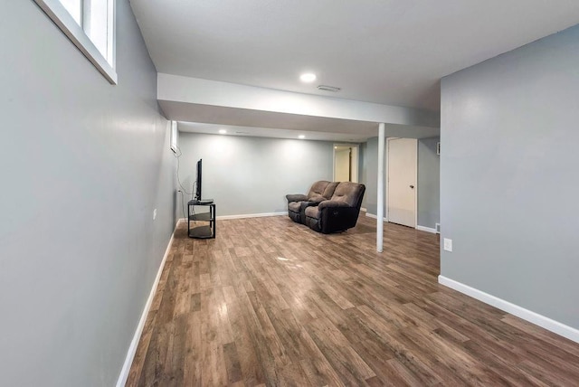 unfurnished room featuring visible vents, baseboards, and wood finished floors