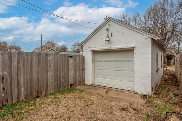 detached garage featuring fence