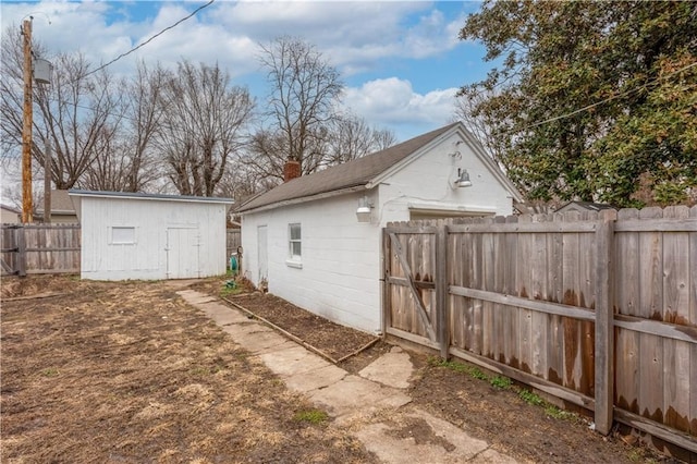 exterior space featuring a storage shed and fence