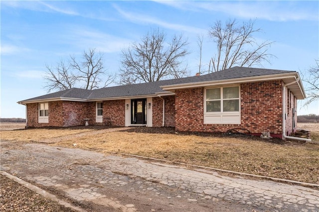 single story home featuring brick siding