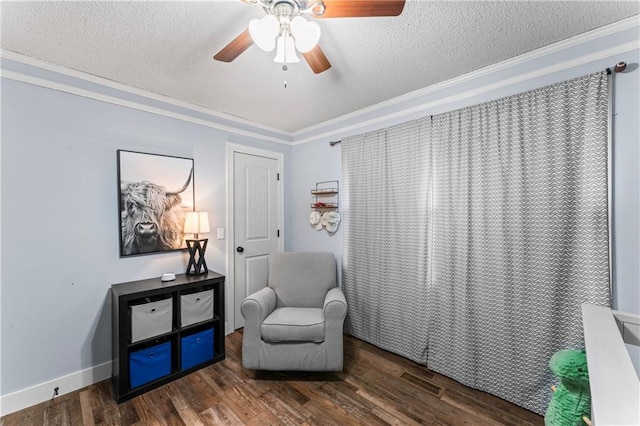 living area featuring ornamental molding, wood finished floors, and a textured ceiling