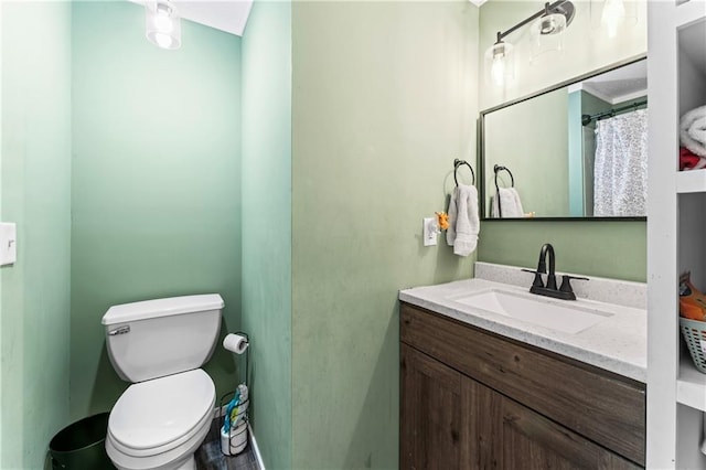 bathroom featuring toilet and vanity