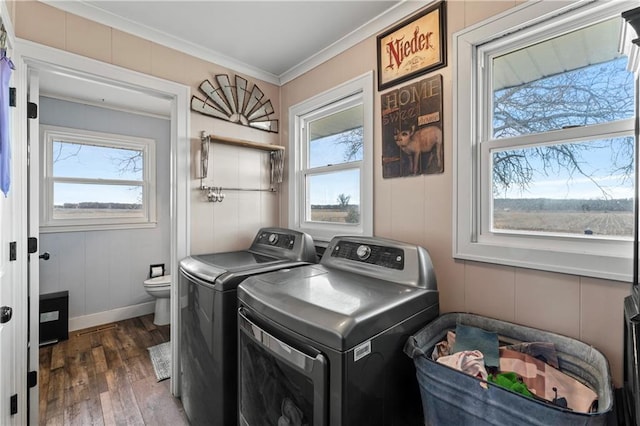 laundry room with wood finished floors, baseboards, laundry area, separate washer and dryer, and ornamental molding