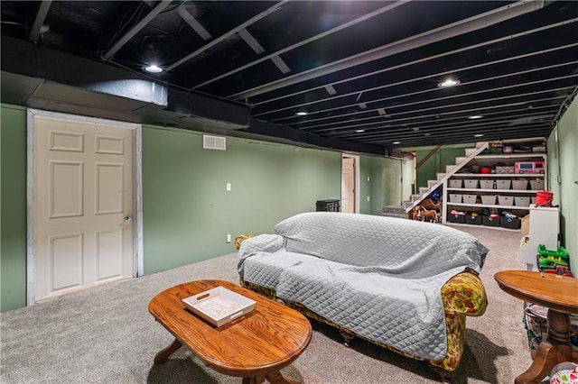 living room with stairway, carpet, and visible vents