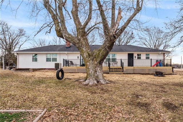 rear view of house featuring central air condition unit and a wooden deck