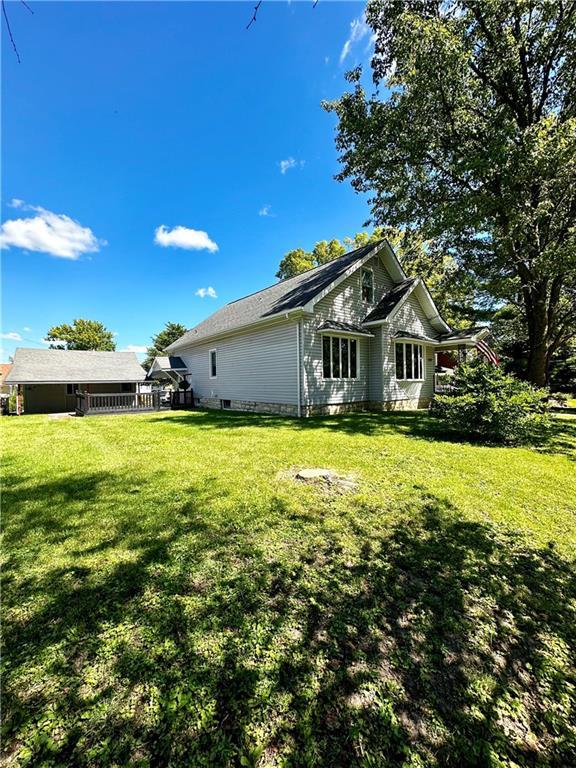 view of property exterior featuring a lawn