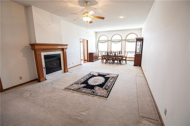 living room with a ceiling fan, carpet, and baseboards