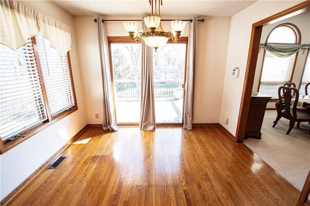 22513 E 33rd St S, Blue Springs, MO 64015 - interior space with visible vents, a notable chandelier, wood finished floors, and baseboards
