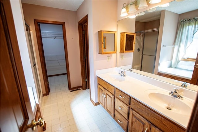 22513 E 33rd St S, Blue Springs, MO 64015 - bathroom featuring double vanity, a shower stall, baseboards, and a sink