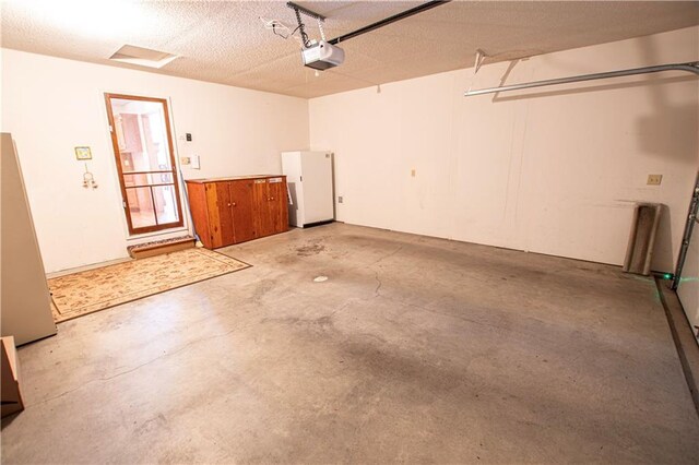 22513 E 33rd St S, Blue Springs, MO 64015 - garage with a garage door opener and freestanding refrigerator