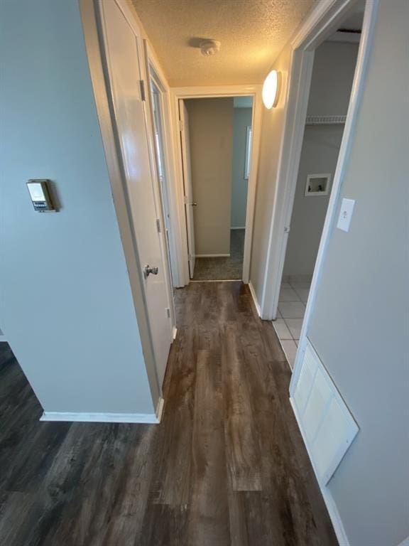 18822 E Wigwam Dr, Independence, MO 64056 - hall featuring baseboards, a textured ceiling, and dark wood finished floors