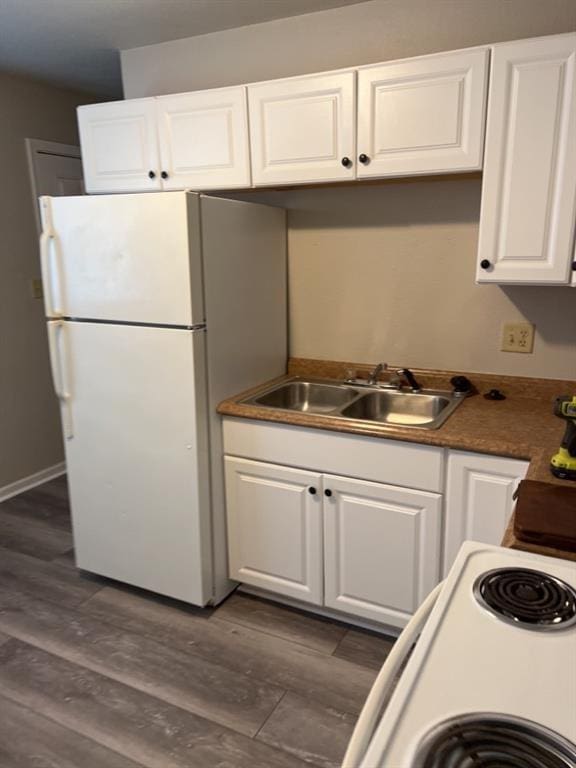 18822 E Wigwam Dr, Independence, MO 64056 - kitchen with baseboards, dark wood-style floors, white appliances, white cabinetry, and a sink