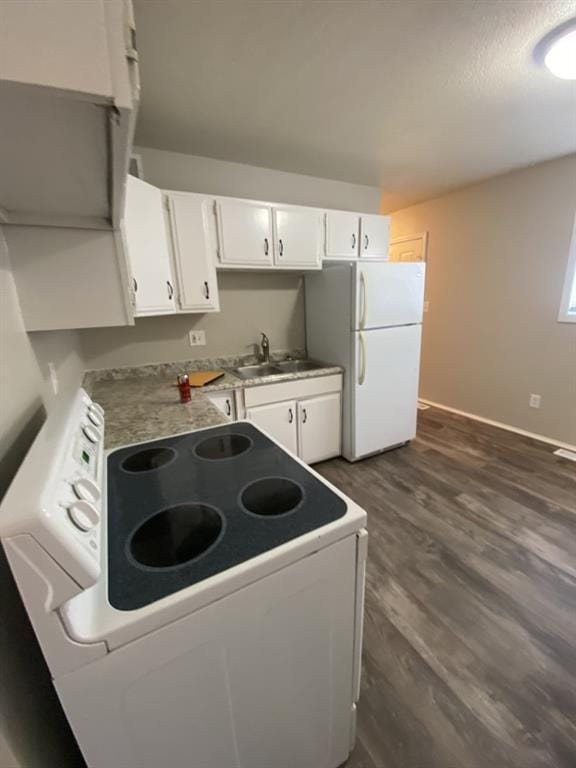 18822 E Wigwam Dr, Independence, MO 64056 - kitchen featuring white appliances, white cabinets, dark wood-style flooring, and a sink