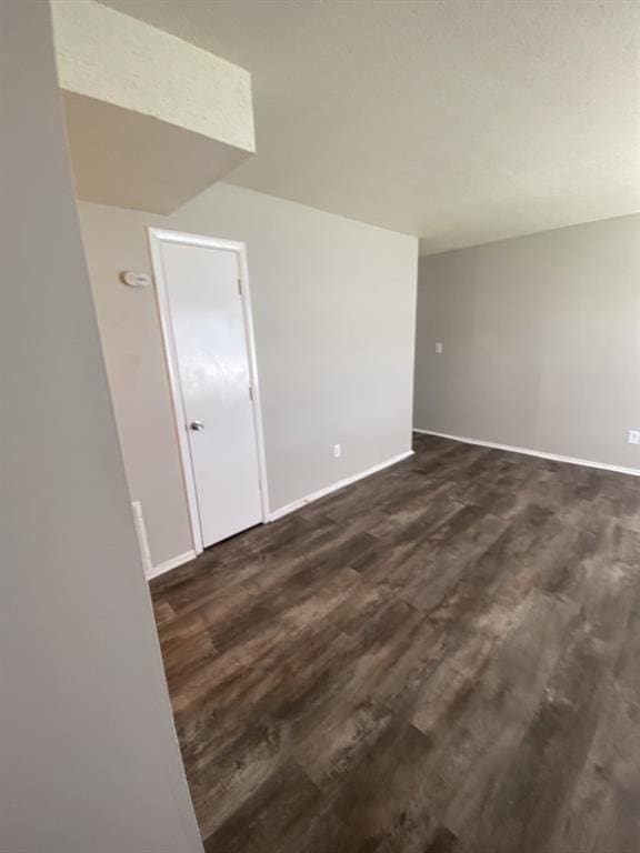 18822 E Wigwam Dr, Independence, MO 64056 - empty room with dark wood finished floors and baseboards