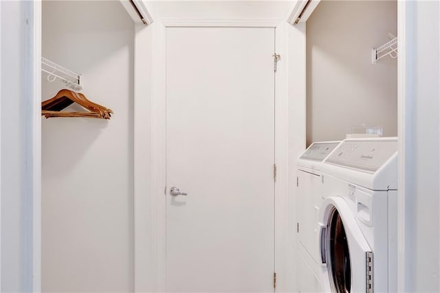 washroom with washing machine and dryer and laundry area