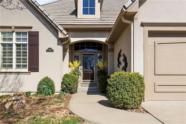 entrance to property featuring stucco siding