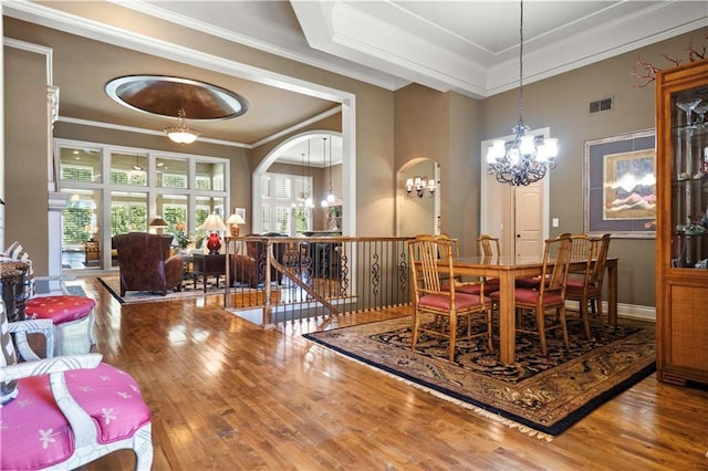 dining area featuring hardwood / wood-style flooring, plenty of natural light, visible vents, and a chandelier