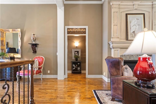 home office featuring wood finished floors, baseboards, and ornamental molding