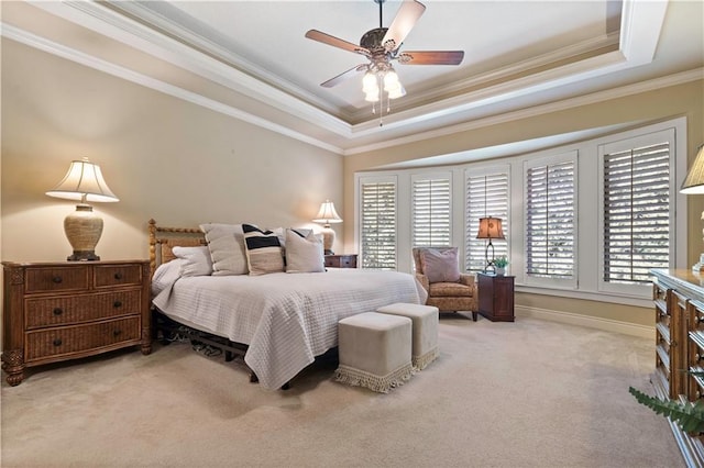 bedroom featuring ceiling fan, baseboards, ornamental molding, light carpet, and a raised ceiling