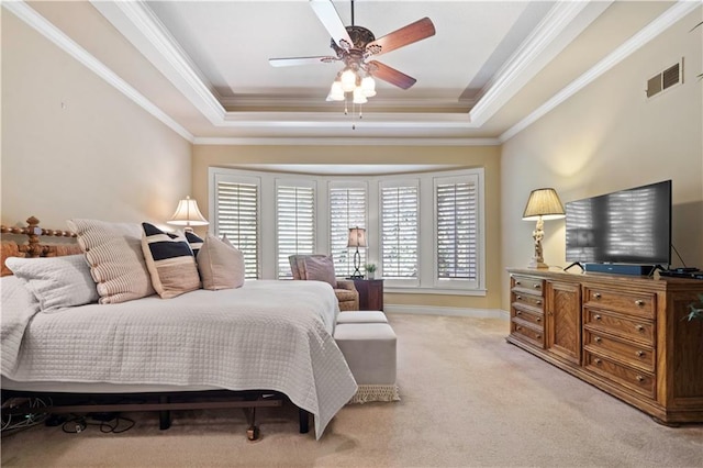 bedroom featuring visible vents, light colored carpet, crown molding, and a raised ceiling