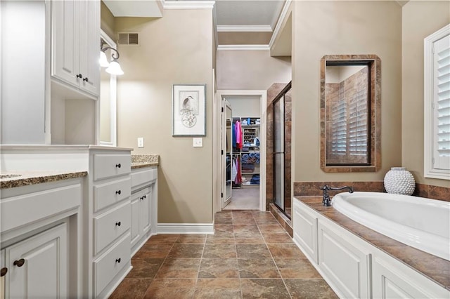 bathroom featuring visible vents, a garden tub, a stall shower, crown molding, and vanity