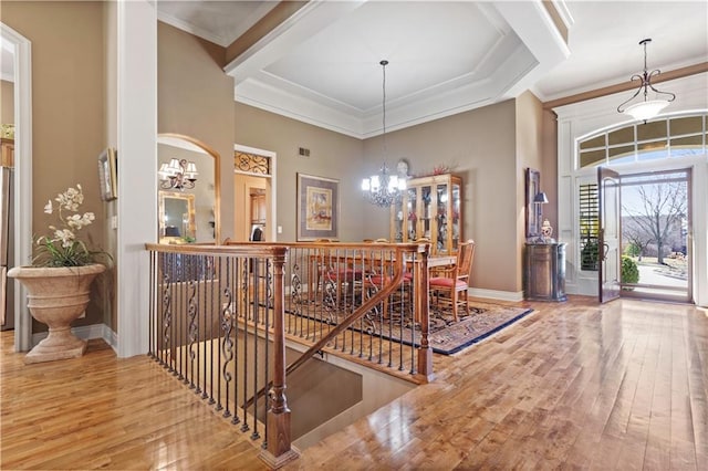 foyer with a chandelier, baseboards, and wood-type flooring