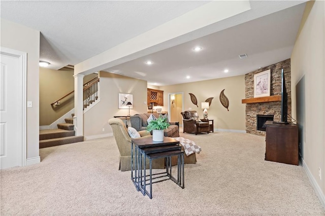 carpeted living area with stairs, recessed lighting, baseboards, and a fireplace