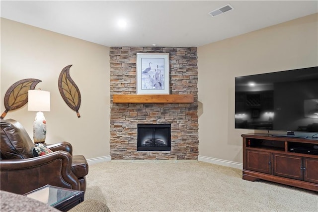 living room featuring light carpet, visible vents, a fireplace, and baseboards