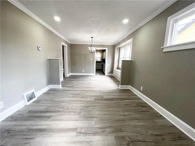 unfurnished dining area featuring a chandelier, visible vents, baseboards, and dark wood-style floors