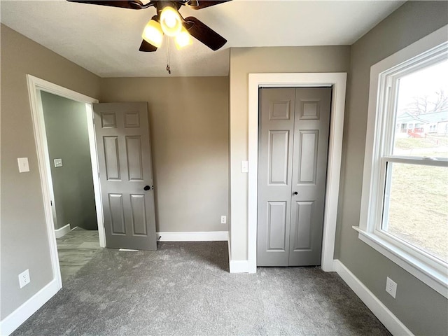 unfurnished bedroom featuring a closet, baseboards, and carpet