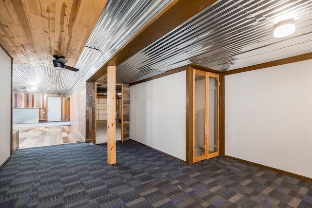 finished basement with baseboards, carpet floors, and wood ceiling