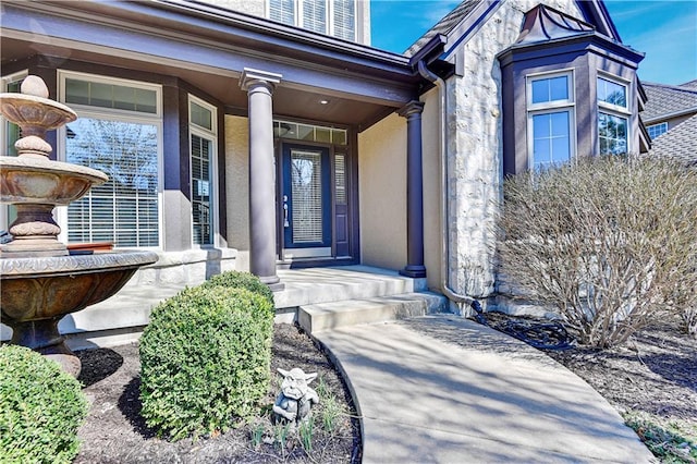 property entrance featuring stucco siding