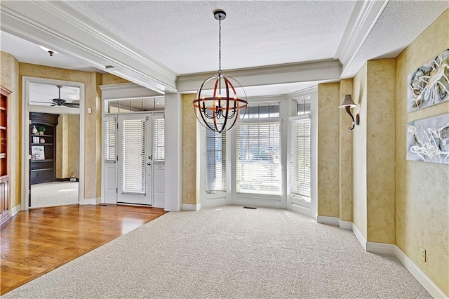 interior space with crown molding, built in features, carpet flooring, and a textured ceiling