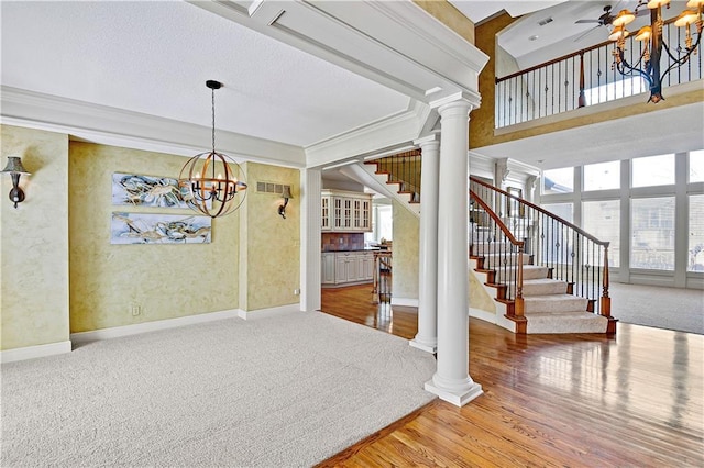 unfurnished dining area with visible vents, carpet flooring, stairs, and an inviting chandelier