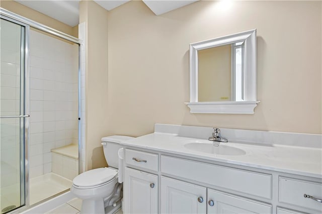 full bathroom featuring vanity, toilet, a stall shower, and tile patterned flooring