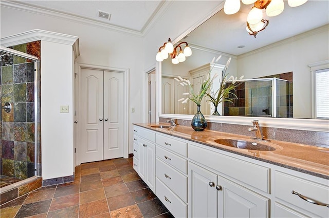 bathroom with double vanity, ornamental molding, a stall shower, and a sink