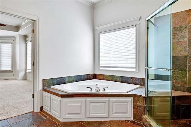 bathroom featuring a shower stall, a bath, visible vents, and ornamental molding