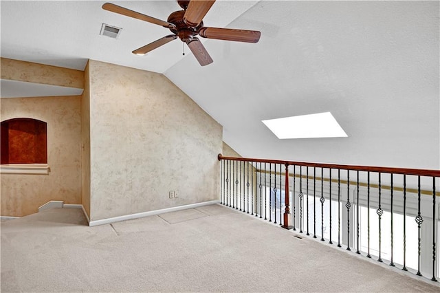 bonus room with visible vents, vaulted ceiling with skylight, carpet floors, and ceiling fan