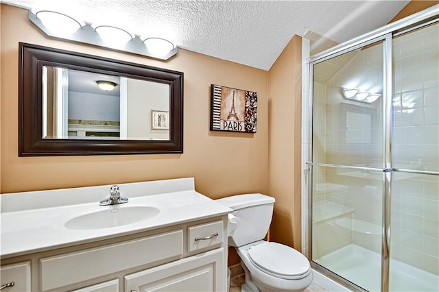 full bathroom with toilet, a stall shower, a textured ceiling, and vanity