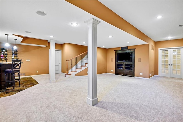 carpeted living room featuring stairway, baseboards, decorative columns, recessed lighting, and a bar