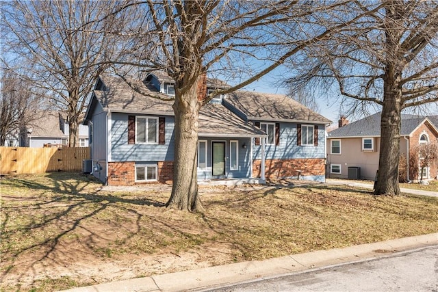 split level home featuring central AC and fence