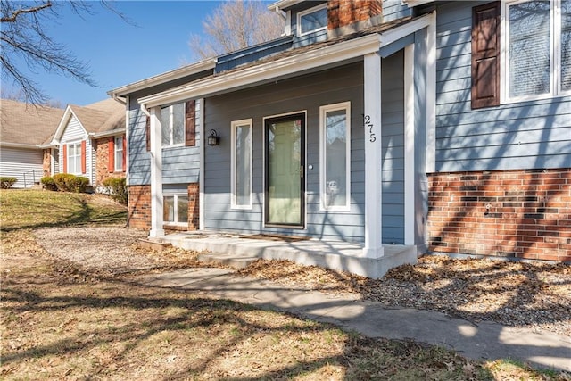 view of exterior entry with covered porch