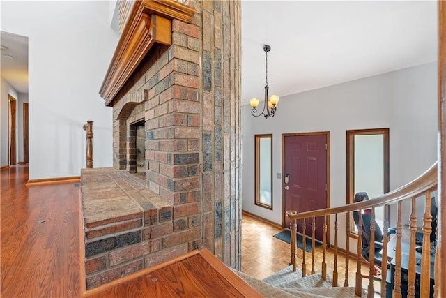 entrance foyer featuring a chandelier, parquet floors, and baseboards