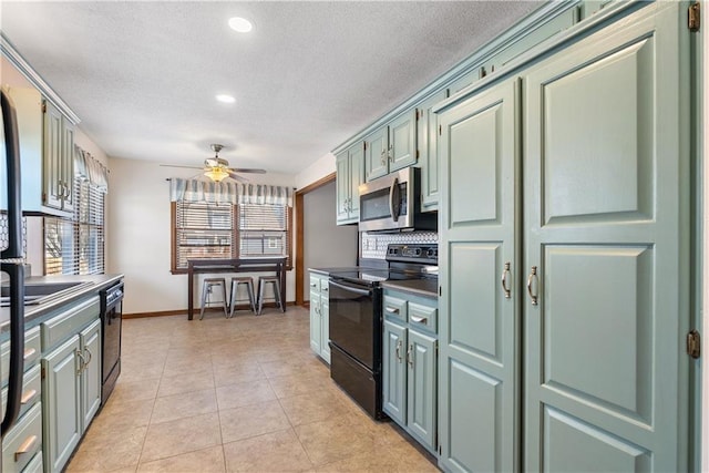 kitchen featuring black appliances, a ceiling fan, a textured ceiling, light tile patterned flooring, and baseboards