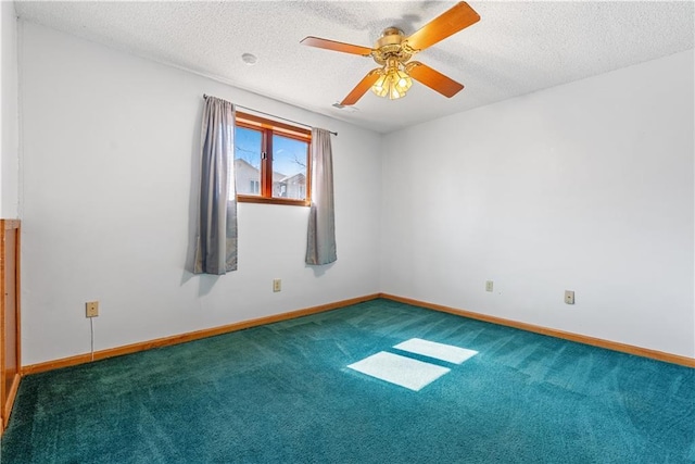 spare room featuring baseboards, a textured ceiling, ceiling fan, and carpet floors