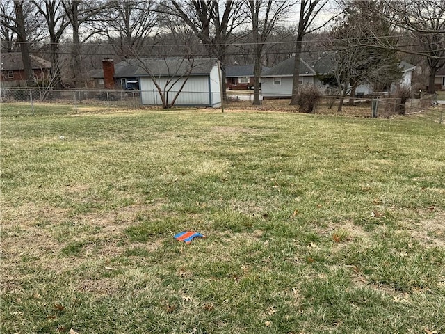 view of yard featuring an outdoor structure and fence