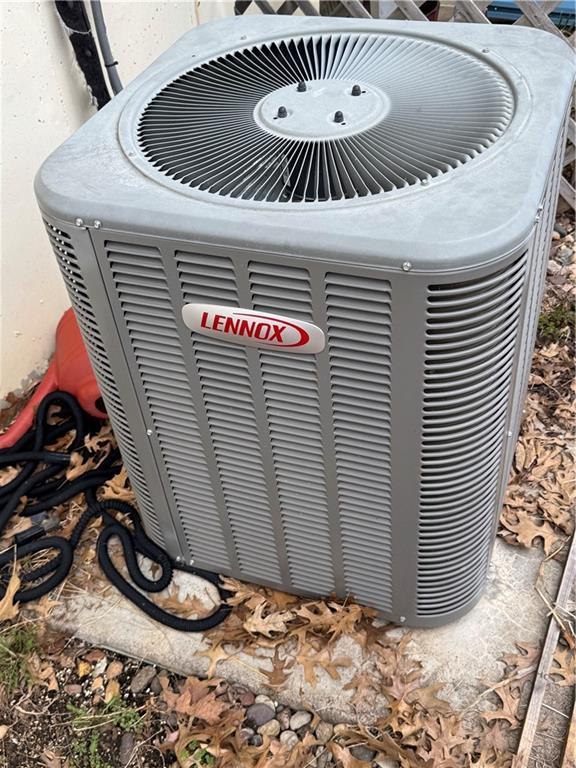 exterior details featuring stucco siding and central AC unit